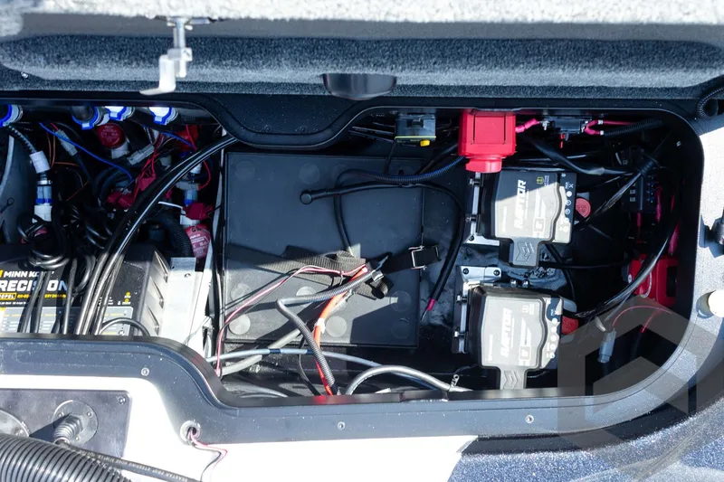 Slide: The Image of Battery compartment of a 2027 Skeeter FXE20 Pro boat, showcasing wiring and components. - 26