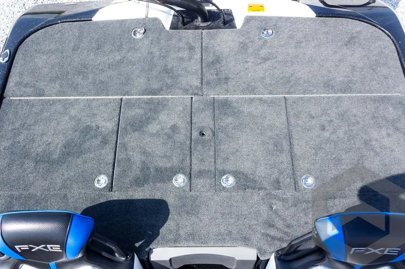 Slide: The Image of 2027 Skeeter FXE20 Pro boat deck with gray carpet and FXE branding. - 20