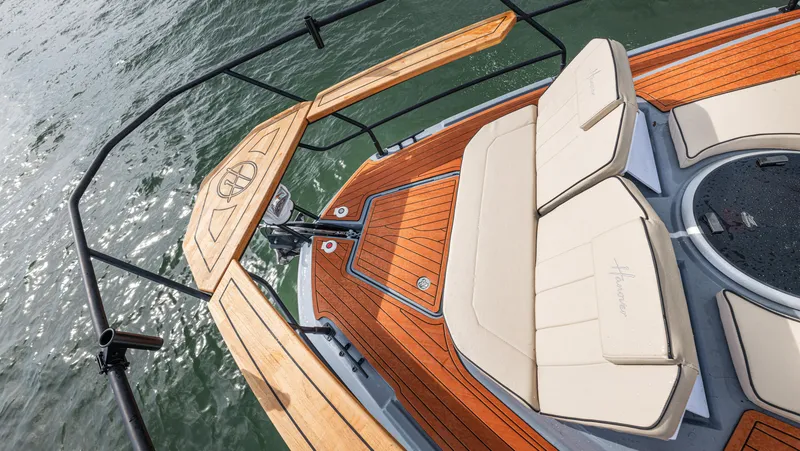 Slide: The Image of The image shows the bow of a 2027 Hanover 415 boat with sleek wooden accents. - 43