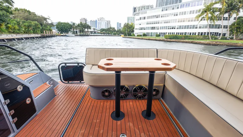 Slide: The Image of The image shows the deck of a 2027 Hanover 415 boat with sleek seating and a wooden table. - 26