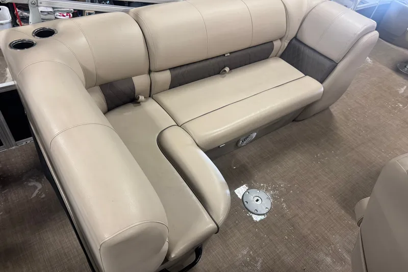 Slide: The Image of 2021 Sun Tracker Fishin' Barge 20 DLX interior seating with beige upholstery and cup holders. - 17