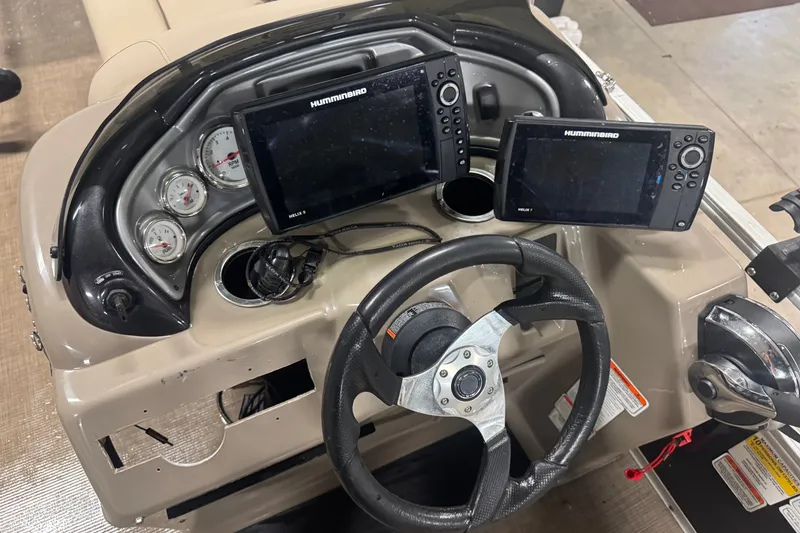 Slide: The Image of 2021 Sun Tracker Fishin' Barge 20 DLX dashboard with Humminbird electronics and steering wheel. - 13