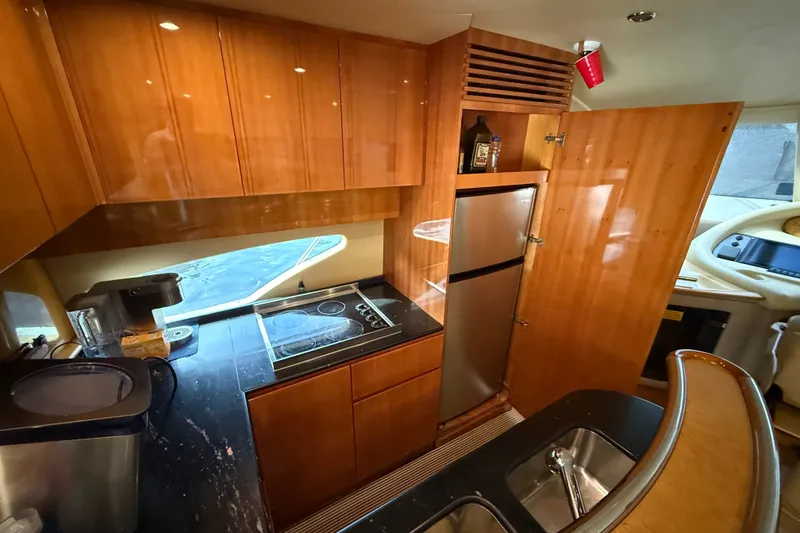 Slide: The Image of Luxurious 2008 Azimut 62E yacht kitchen with modern appliances and sleek wooden cabinetry. - 27