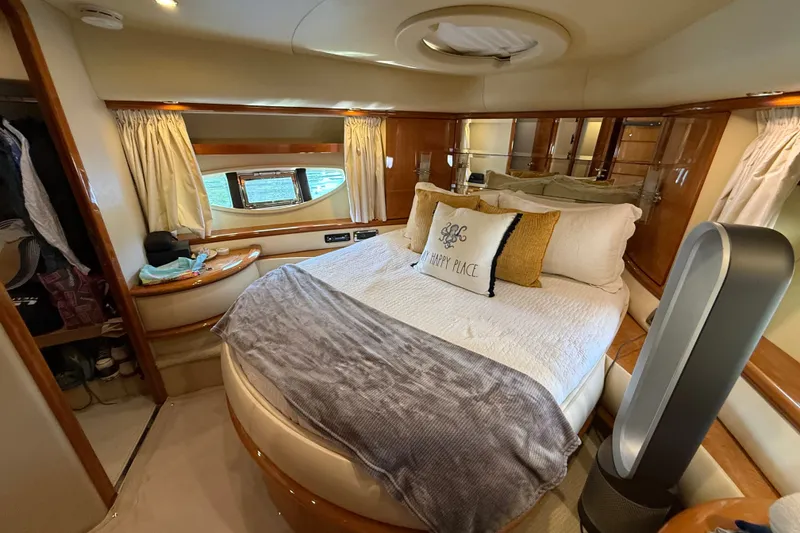 Slide: The Image of Luxurious bedroom interior of a 2008 Azimut 62E yacht with cozy bedding and elegant decor. - 44