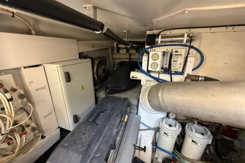 Slide: The Image of Engine room of a 2008 Azimut 62E yacht, featuring mechanical and electrical components. - 58