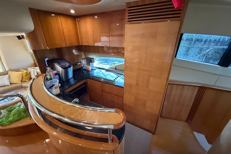 Slide: The Image of Luxurious kitchen interior of 2008 Azimut 62E yacht with wooden cabinetry and modern appliances. - 26
