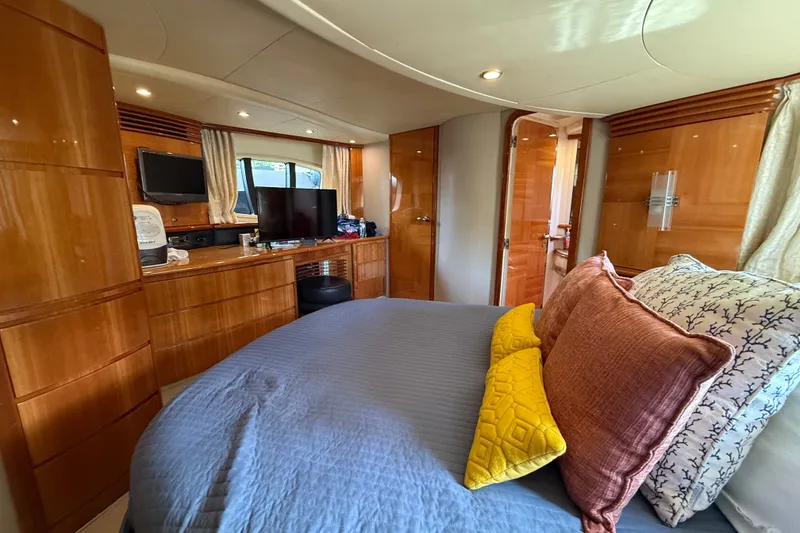 Slide: The Image of Luxurious interior of a 2008 Azimut 62E yacht with elegant wood finishes and cozy bedding. - 36