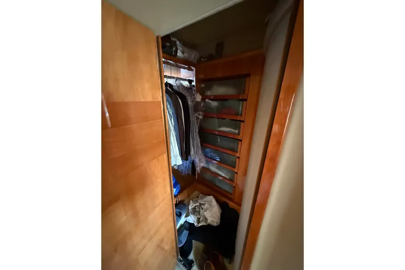 Slide: The Image of Wooden closet interior on 2008 Azimut 62E yacht, featuring hanging clothes and shelves. - 40