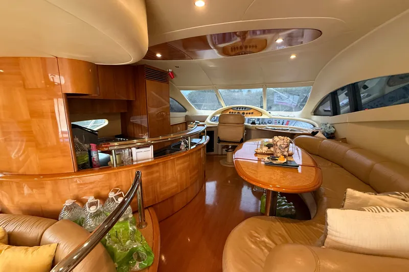 Slide: The Image of Luxurious interior of a 2008 Azimut 62E yacht with elegant wood finishes and plush seating. - 24
