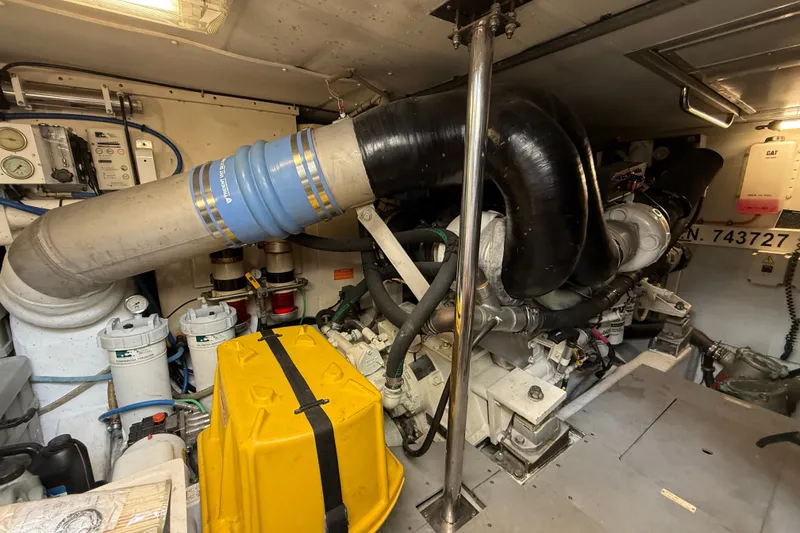 Slide: The Image of Engine room of a 2008 Azimut 62E yacht, showcasing mechanical components and equipment. - 53