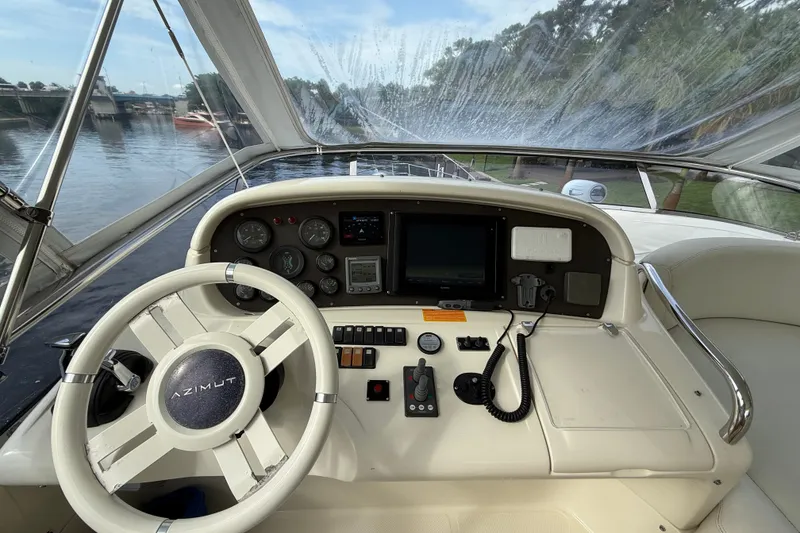 Slide: The Image of Cockpit view of 2008 Azimut 62E yacht with steering wheel and navigation controls. - 7