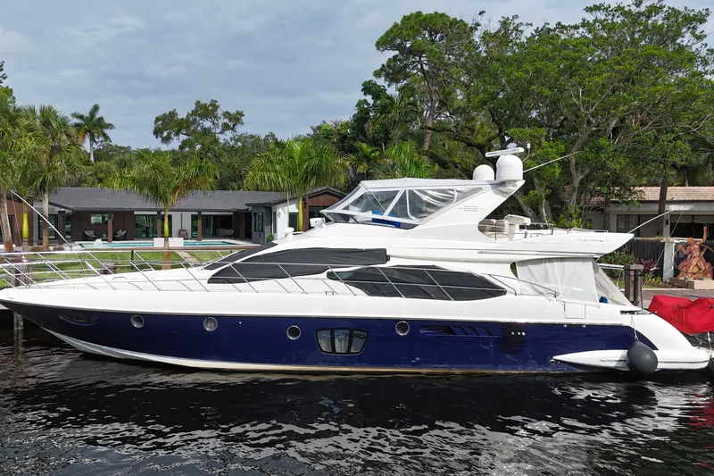 Slide: The Image of 2008 Azimut 62E yacht docked by lush waterfront property. - 60