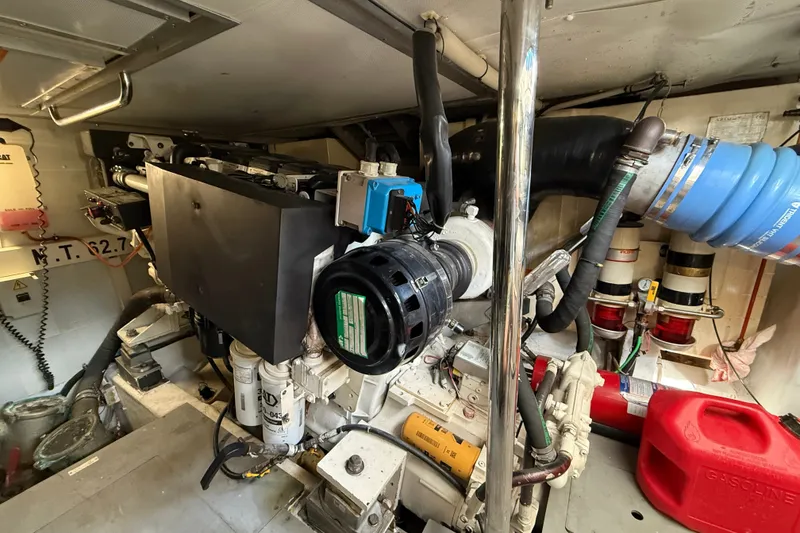 Slide: The Image of Engine room of a 2008 Azimut 62E yacht, showcasing mechanical components and equipment. - 54