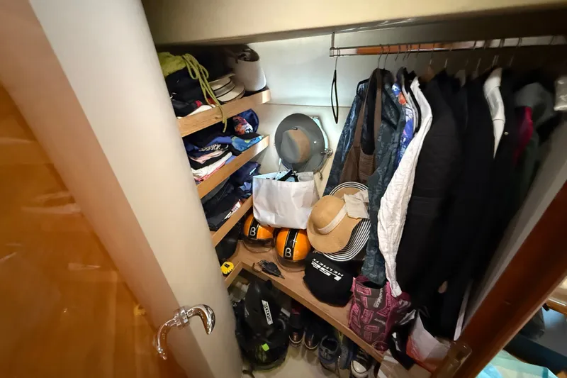 Slide: The Image of Closet on 2008 Azimut 62E yacht with clothes, hats, and accessories neatly organized. - 45