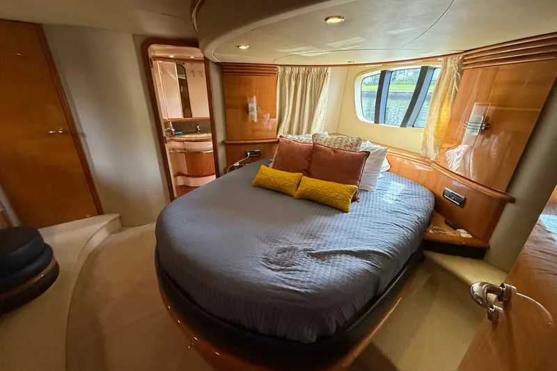 Slide: The Image of Luxurious bedroom interior of a 2008 Azimut 62E yacht with elegant furnishings and large windows. - 35