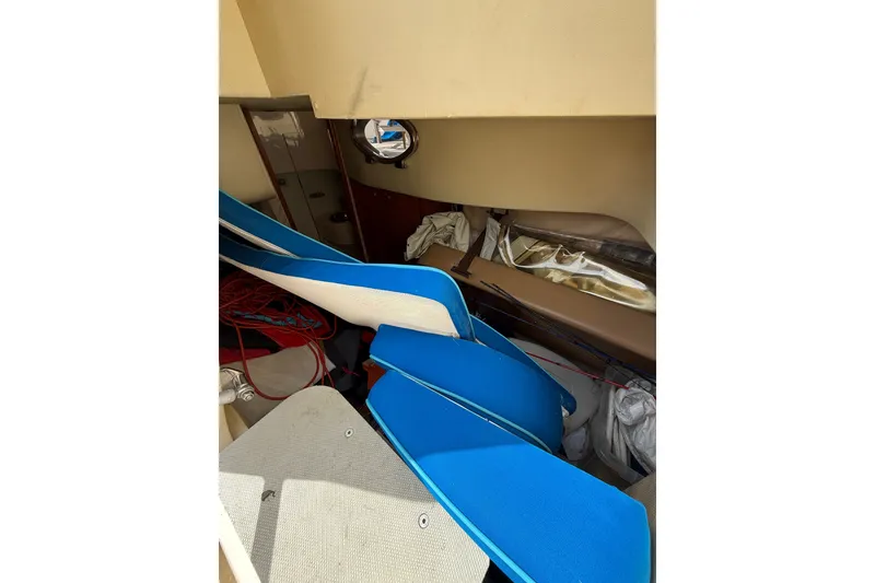 Slide: The Image of Interior view of 2008 Azimut 62E yacht with blue cushions and storage area. - 51