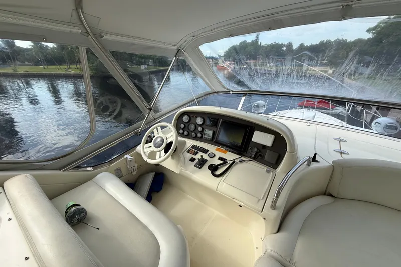 Slide: The Image of Cockpit view of 2008 Azimut 62E yacht with steering wheel and navigation controls. - 10