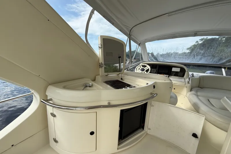 Slide: The Image of Interior view of 2008 Azimut 62E yacht with helm and seating area. - 9
