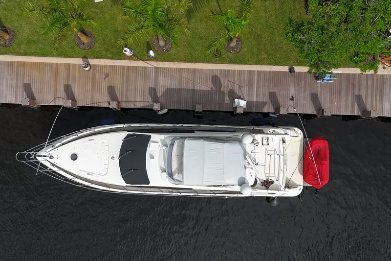 Slide: The Image of Overhead view of a 2008 Azimut 62E yacht docked by a wooden pier. - 66