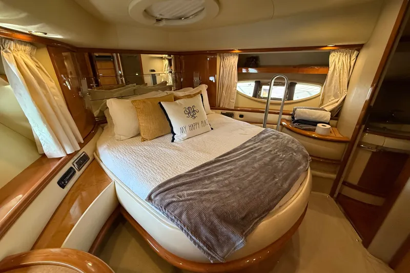 Slide: The Image of Luxurious bedroom interior of a 2008 Azimut 62E yacht with elegant bedding and wood finishes. - 43
