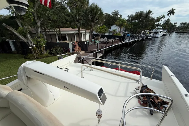Slide: The Image of 2008 Azimut 62E yacht docked by a scenic waterfront with lush greenery. - 12
