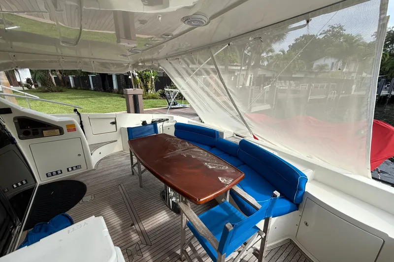 Slide: The Image of 2008 Azimut 62E yacht interior with blue seating and wooden table. - 16