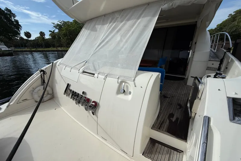 Slide: The Image of 2008 Azimut 62E yacht stern view with deck and seating area. - 17