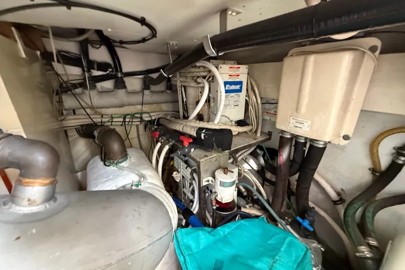 Slide: The Image of Engine room of a 2008 Azimut 62E yacht, showcasing mechanical components and wiring. - 59