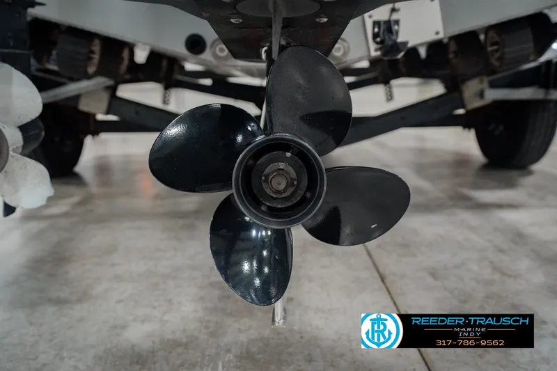Slide: The Image of Propeller of a 1999 Lund Mr. Pike 17 boat on a trailer indoors. - 49