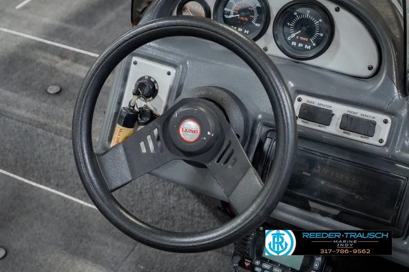 Slide: The Image of Steering wheel and dashboard of 1999 Lund Mr. Pike 17 boat. - 32