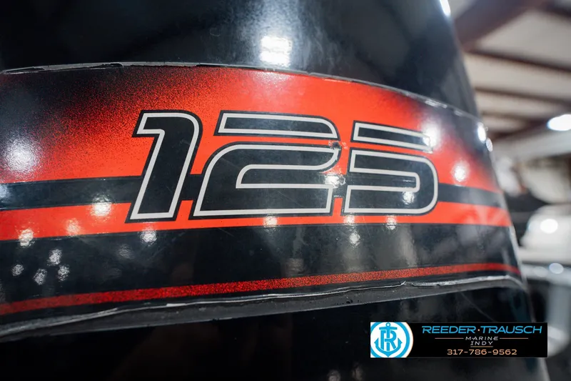 Slide: The Image of Close-up of 125 decal on 1999 Lund Mr. Pike 17 boat engine. - 48