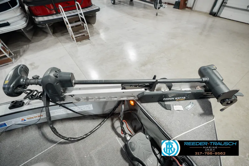 Slide: The Image of 1999 Lund Mr. Pike 17 boat with Minn Kota trolling motor in a showroom. - 54