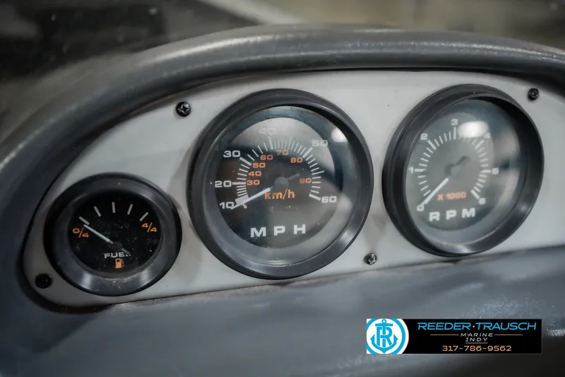 Slide: The Image of Dashboard of a 1999 Lund Mr. Pike 17 boat showing fuel, speed, and RPM gauges. - 35