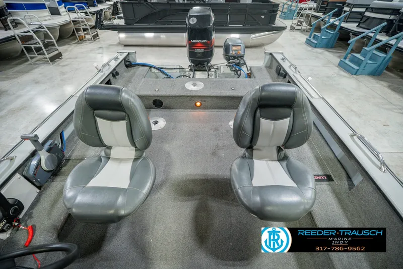 Slide: The Image of 1999 Lund Mr. Pike 17 boat interior with two seats and Mercury outboard motor. - 22