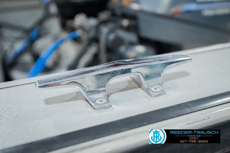 Slide: The Image of Close-up of a 1999 Lund Mr. Pike 17 boat cleat, with Reeder Trausch Marine logo. - 58