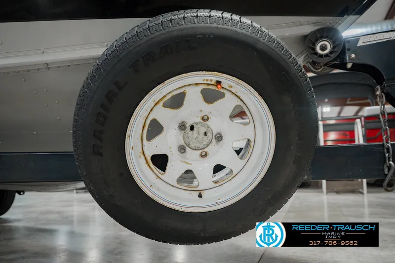 Slide: The Image of Trailer wheel of a 1999 Lund Mr. Pike 17 boat, featuring a radial tire. - 61