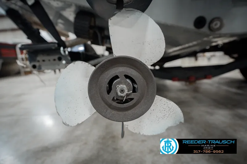 Slide: The Image of Close-up of a 1999 Lund Mr. Pike 17 boat propeller in a garage setting. - 53