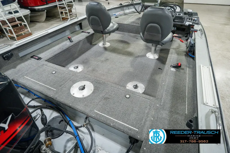 Slide: The Image of 1999 Lund Mr. Pike 17 boat interior with two swivel seats and carpeted deck. - 14