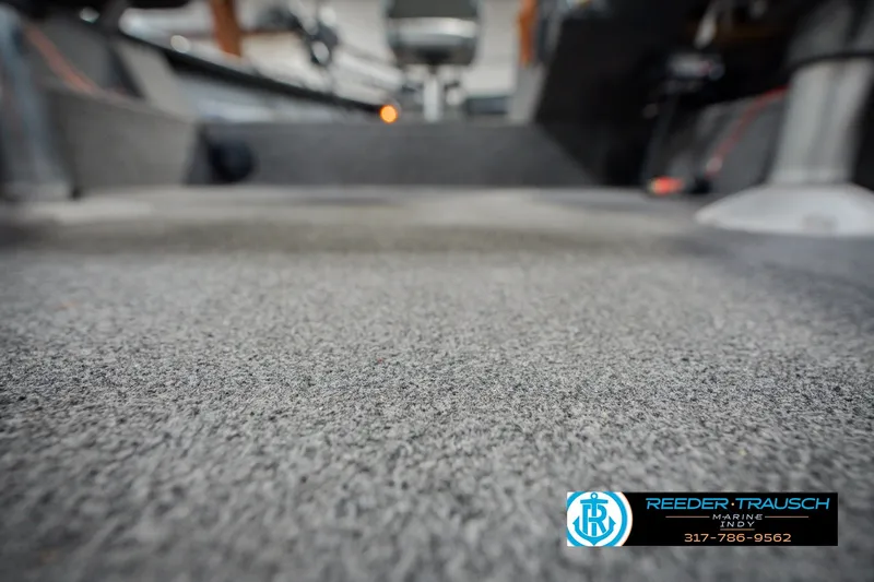 Slide: The Image of Carpeted interior of a 1999 Lund Mr. Pike 17 boat, showcasing flooring details. - 45