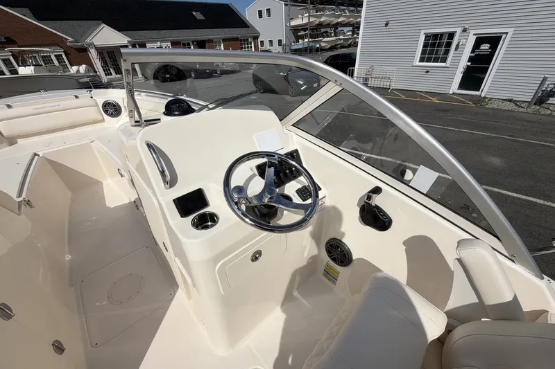 Slide: The Image of The image shows the cockpit of a Grady-White Freedom 215 boat with a modern helm. - 8
