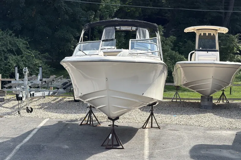 The Image of A 2027 Grady-White Freedom 215 boat is on stands in a parking area. - 1