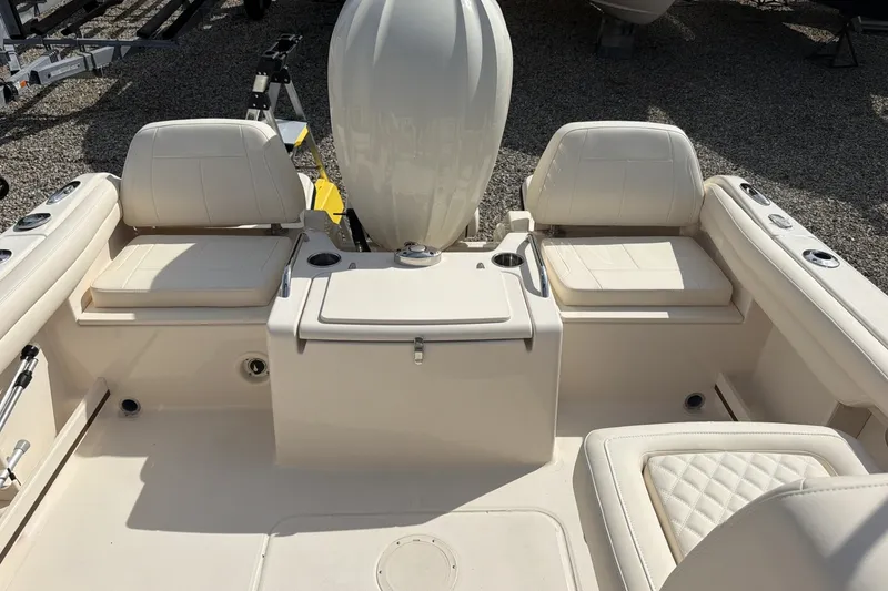 Slide: The Image of The image shows the interior of a Grady-White Freedom 215 boat with beige seating. - 6
