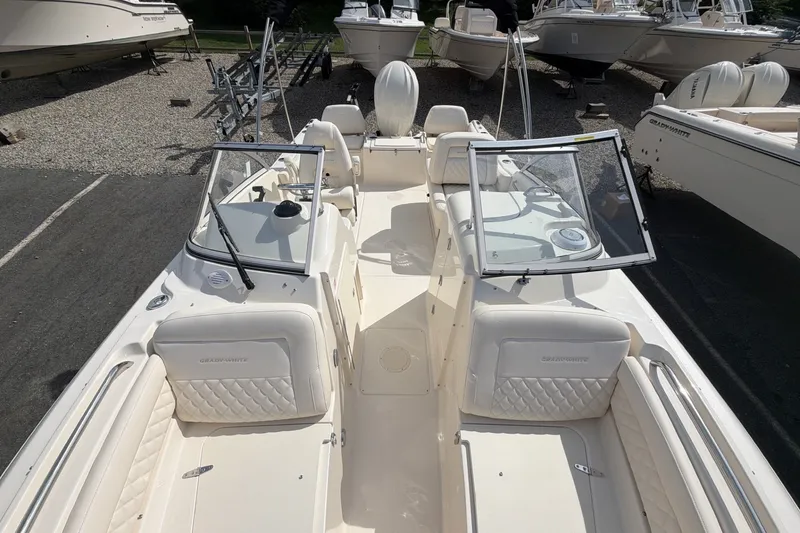 Slide: The Image of The image shows a 2027 Grady-White Freedom 215 boat with an open cabin and comfortable seating. - 10