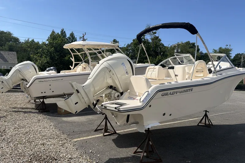 Slide: The Image of Two Grady-White Freedom 215 boats are on stands in an outdoor area. - 4