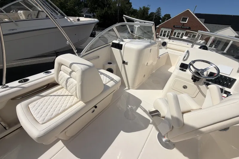 Slide: The Image of The image shows the cockpit of a 2027 Grady-White Freedom 215 with sleek white seating. - 7
