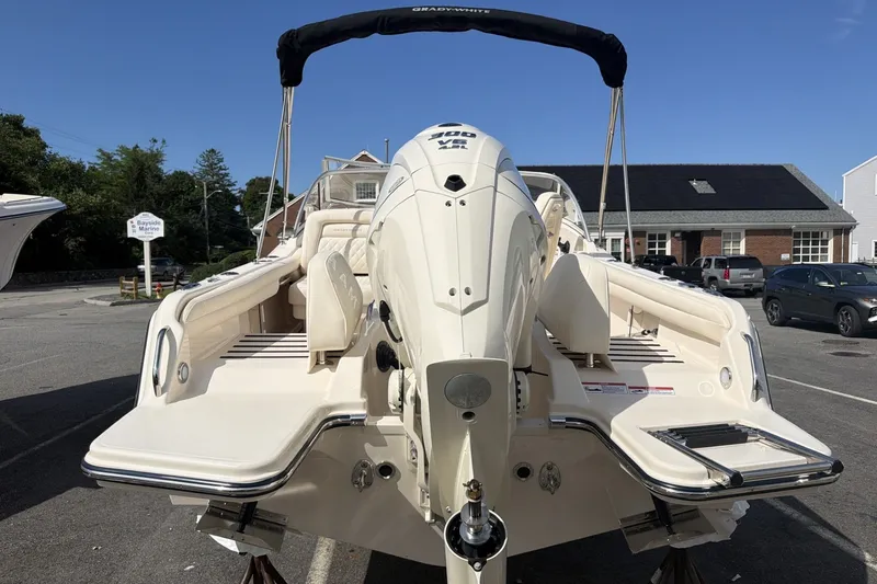 Slide: The Image of 2027 Grady-White Freedom 215 with a powerful outboard motor, parked in a lot. - 5