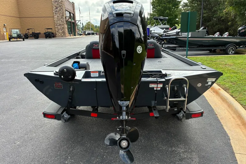 Slide: The Image of 2023 Ranger RT178 boat with outboard motor, parked on a trailer in a lot. - 4