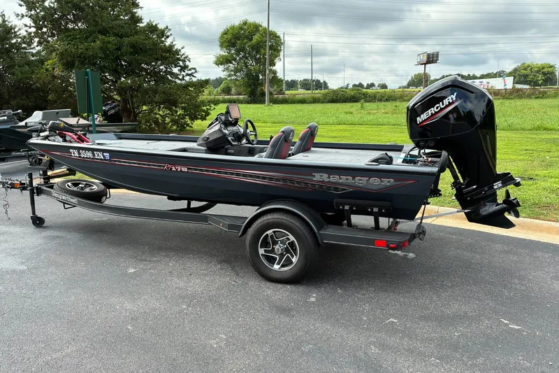 Slide: The Image of 2023 Ranger RT178 boat with Mercury engine on trailer, parked outdoors. - 2
