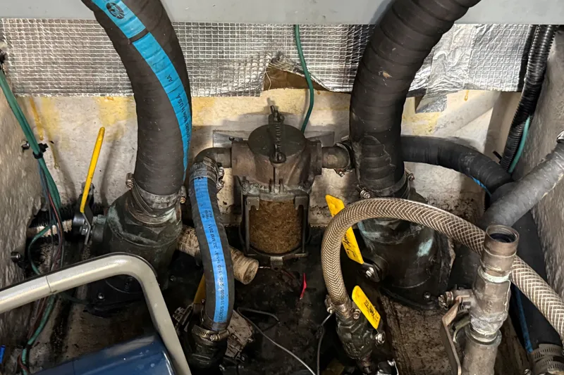 Slide: The Image of Engine compartment of a 1994 Sea Ray 500 Sundancer with hoses and mechanical components. - 58