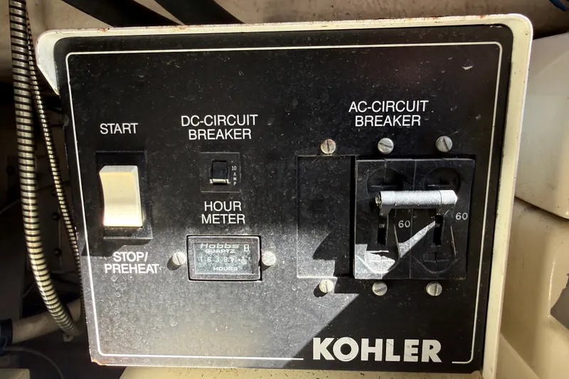 Slide: The Image of Control panel of a 1994 Sea Ray 500 Sundancer with Kohler circuit breakers. - 50